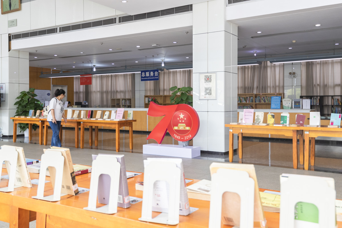 一位同学正在参观图书馆二楼大厅举行的“70年：影响中国人精神成长的文学作品展” 【学通社记者 章洁瑜 摄】